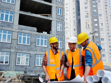 Construction professionals coordinating project details at building site in Los Angeles